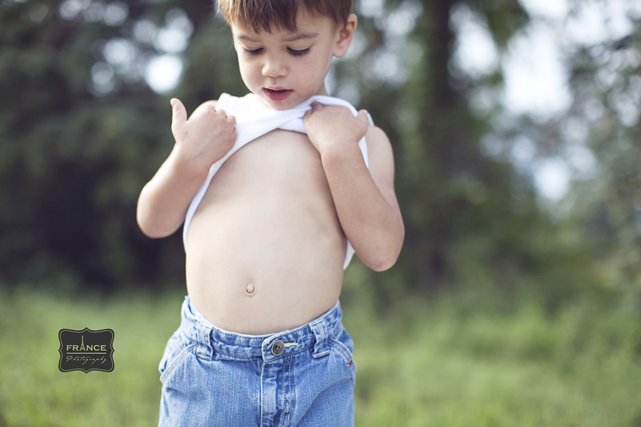 little boy looking for his belly button